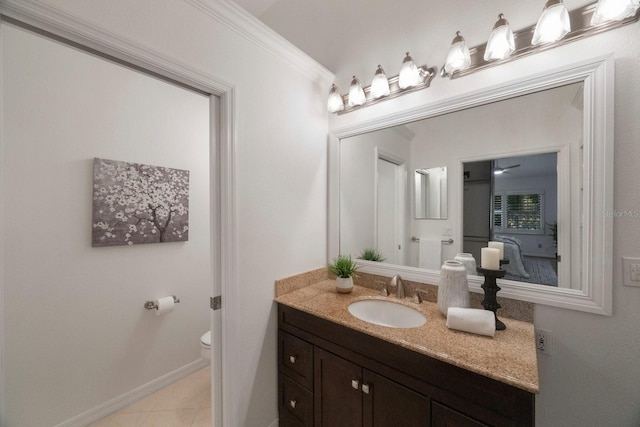 bathroom with tile patterned flooring, toilet, ornamental molding, and vanity