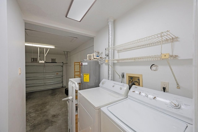 laundry area with water heater, laundry area, washing machine and clothes dryer, and a garage