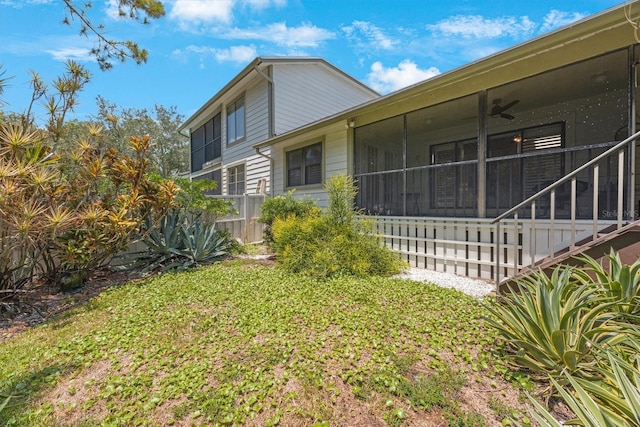 exterior space featuring a sunroom and a ceiling fan