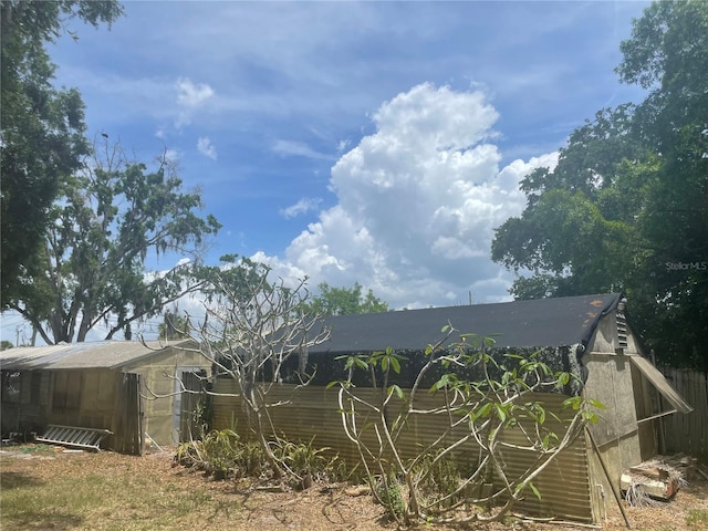 rear view of property featuring an outdoor structure