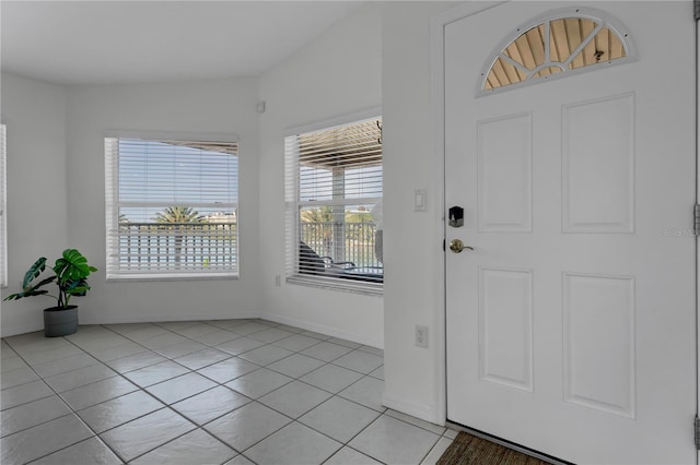 entryway featuring light tile patterned floors and baseboards