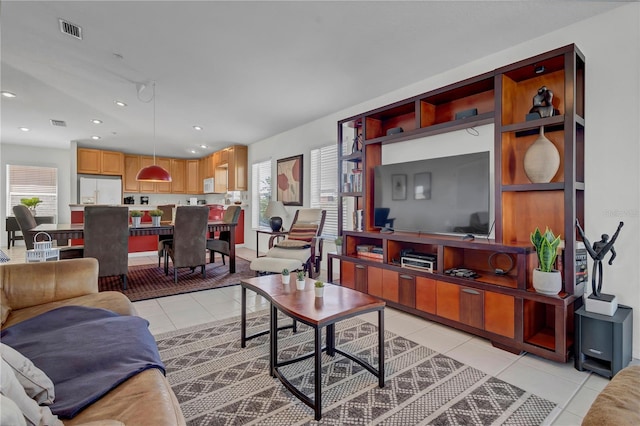 tiled living room with a healthy amount of sunlight