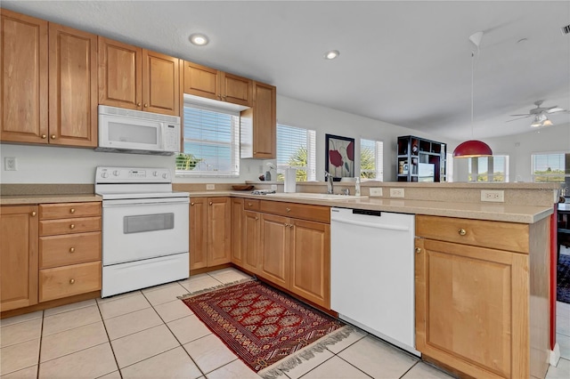 kitchen with sink, light tile patterned floors, kitchen peninsula, white appliances, and ceiling fan