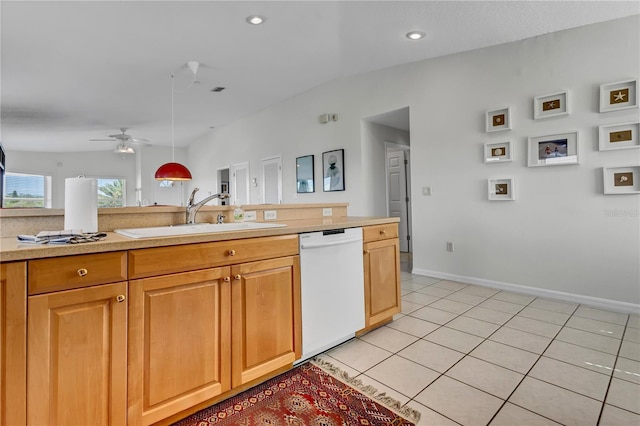 kitchen featuring white dishwasher, a sink, light countertops, a ceiling fan, and light tile patterned flooring