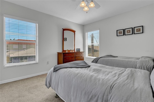 bedroom with carpet flooring, baseboards, and a ceiling fan