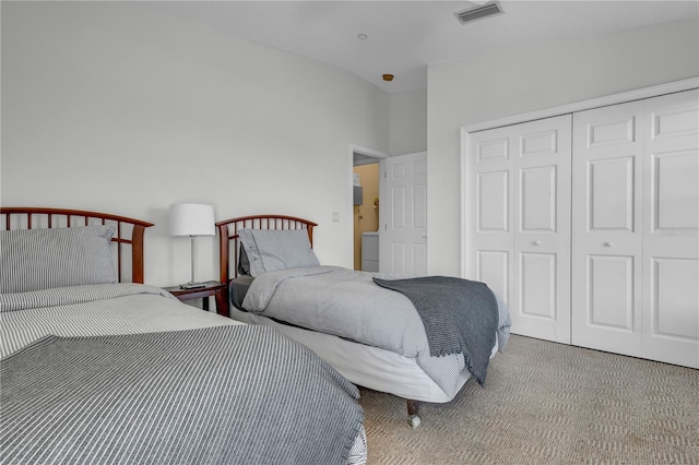 bedroom with a closet, carpet floors, and lofted ceiling