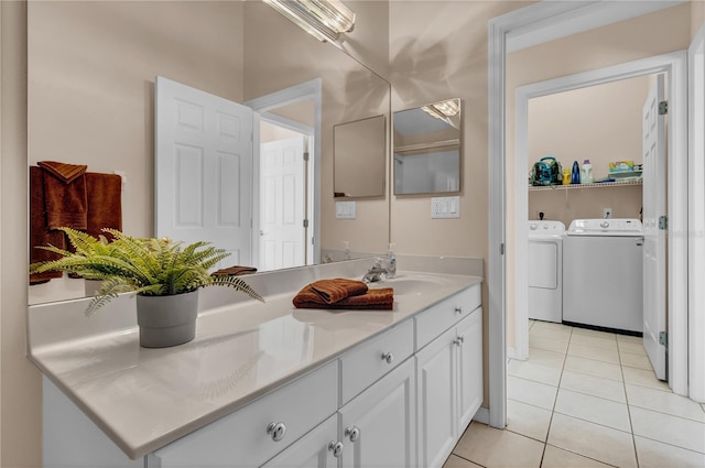 bathroom featuring washer and dryer, tile patterned flooring, and vanity