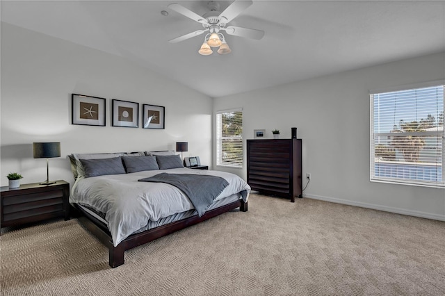 bedroom with multiple windows, vaulted ceiling, light colored carpet, and ceiling fan