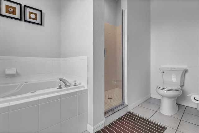 bathroom with tile patterned floors, independent shower and bath, and toilet