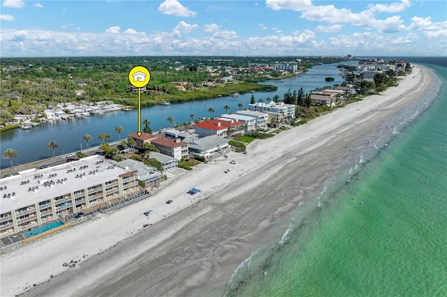 birds eye view of property featuring a beach view and a water view