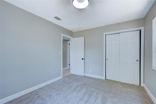 unfurnished bedroom featuring a closet and carpet flooring