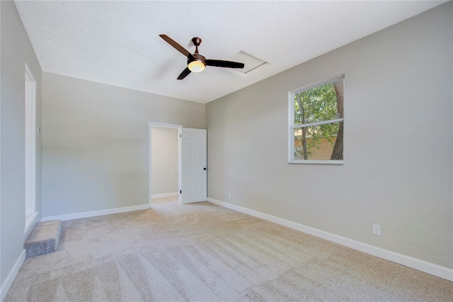 carpeted empty room featuring ceiling fan