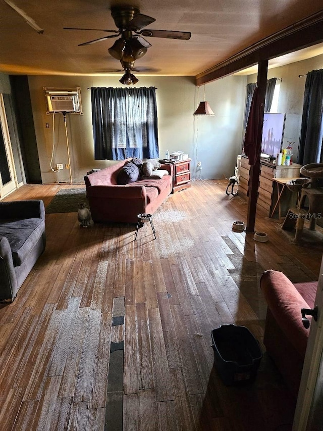 interior space featuring a wall mounted AC, hardwood / wood-style floors, and ceiling fan