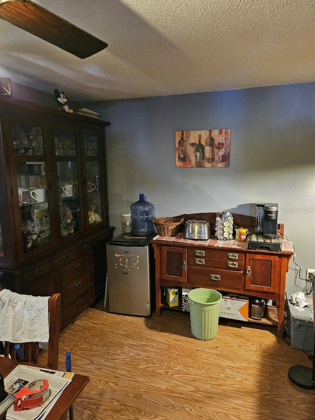 office area featuring hardwood / wood-style flooring and a textured ceiling