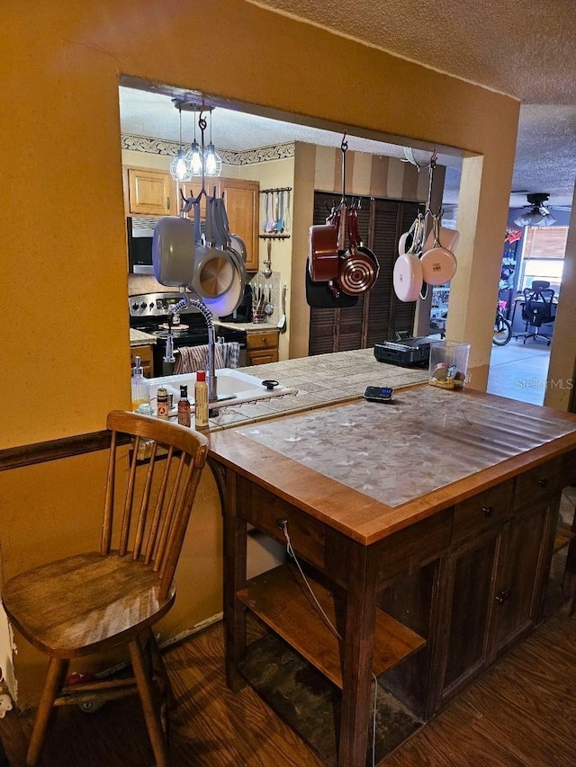 dining area featuring dark wood-type flooring and a textured ceiling