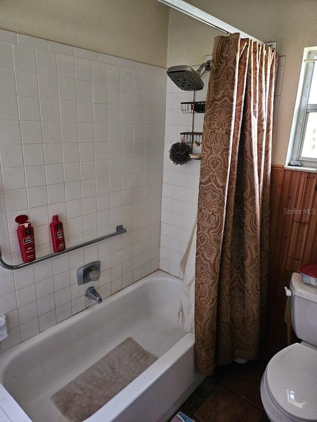 bathroom featuring tile flooring, toilet, and shower / tub combo with curtain