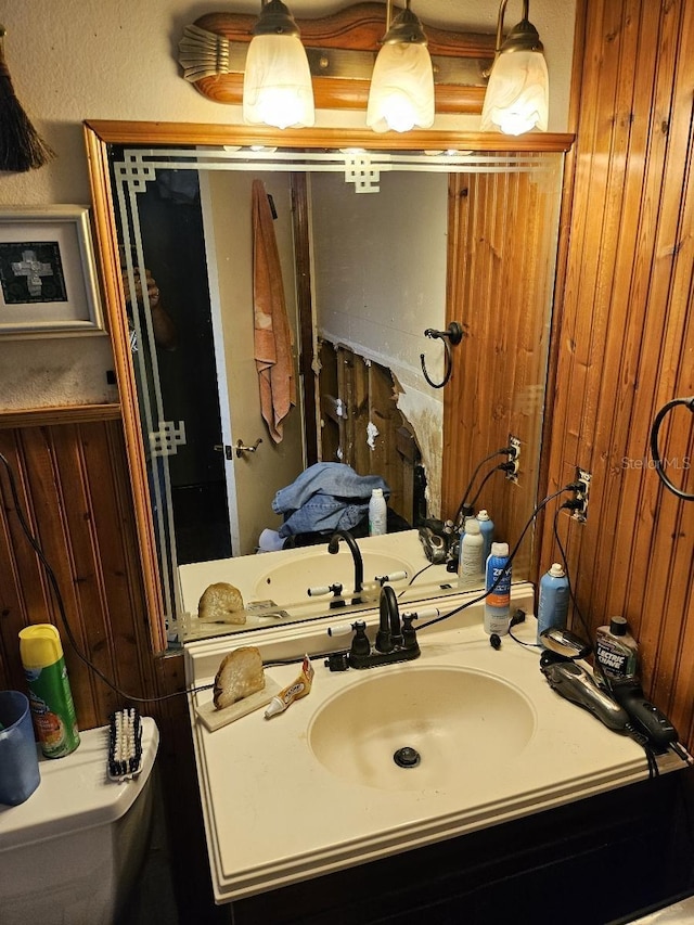 bathroom with sink and wooden walls