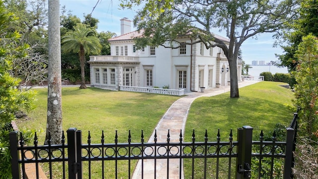 rear view of property with a lawn