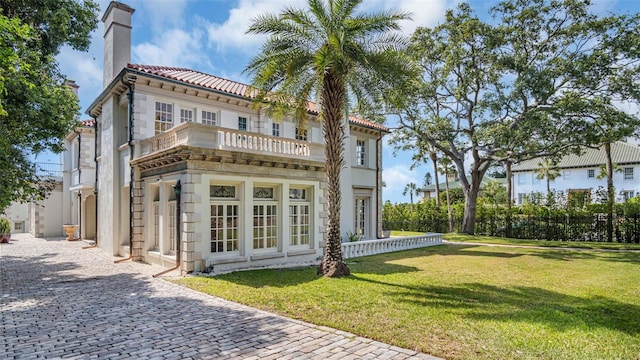 rear view of property featuring a yard