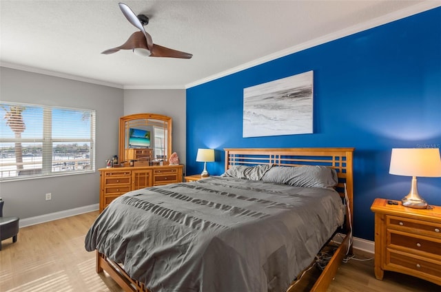 bedroom featuring ceiling fan, crown molding, and hardwood / wood-style flooring