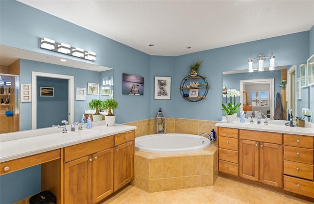 bathroom featuring a relaxing tiled bath, dual bowl vanity, and tile flooring