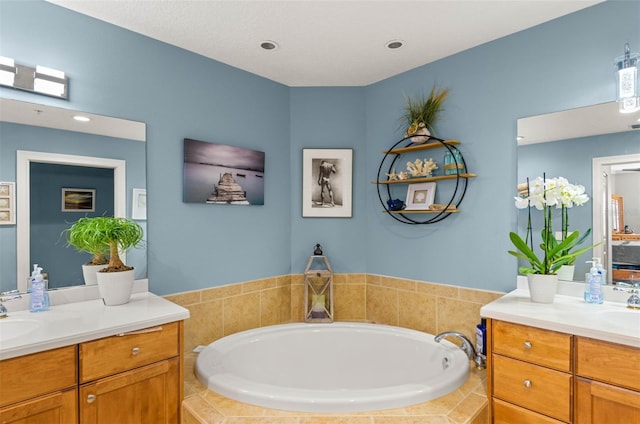 bathroom featuring oversized vanity and a relaxing tiled bath