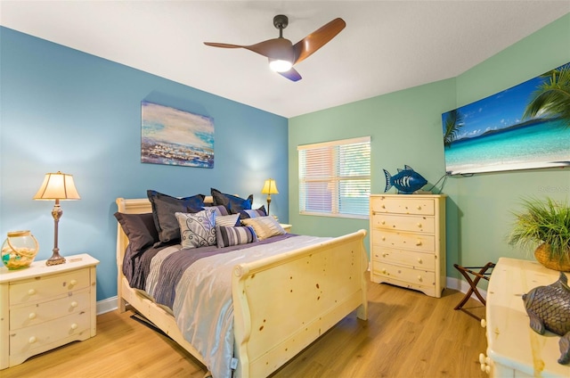 bedroom with light hardwood / wood-style floors and ceiling fan