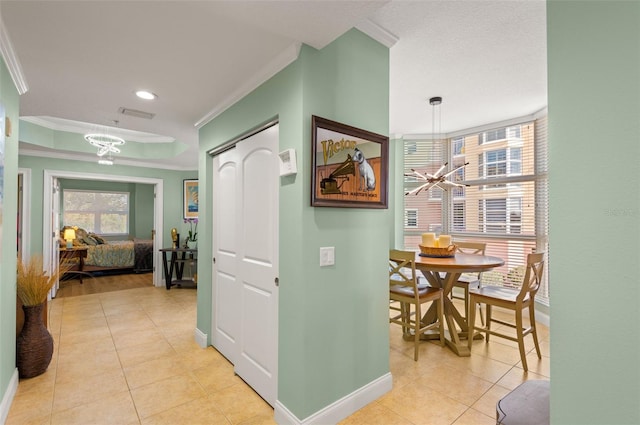 hall featuring crown molding and light tile flooring