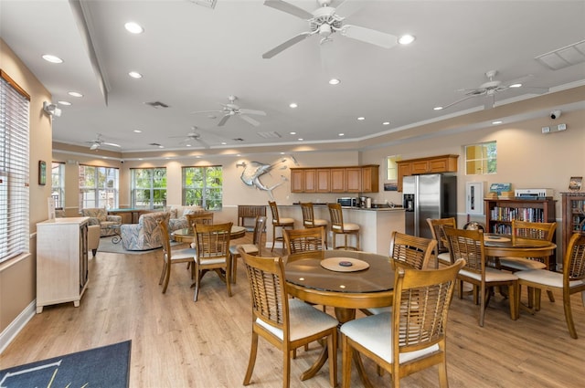 dining space featuring light hardwood / wood-style floors and ceiling fan