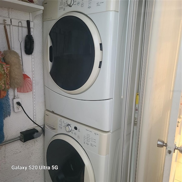 laundry area with stacked washer / drying machine