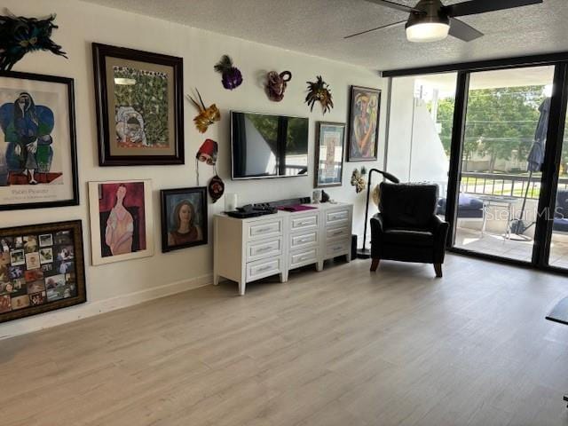 living area featuring a textured ceiling and light wood-type flooring