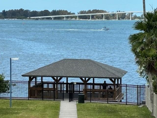 view of dock with a gazebo and a water view