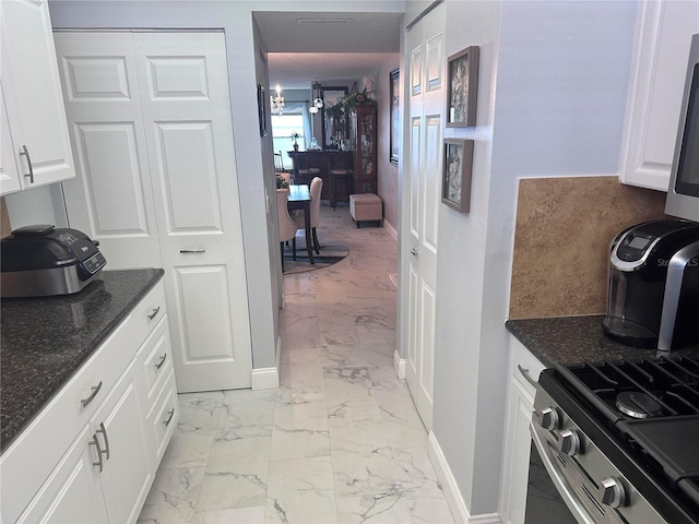 kitchen with dark stone counters and white cabinets