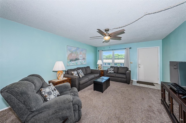 living room featuring a textured ceiling, ceiling fan, and carpet flooring