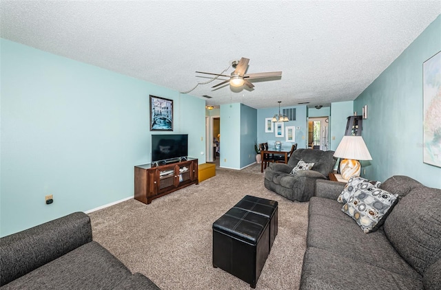 living room with ceiling fan with notable chandelier, a textured ceiling, and carpet flooring