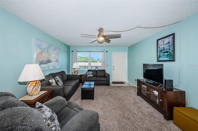 carpeted living room with a textured ceiling and ceiling fan