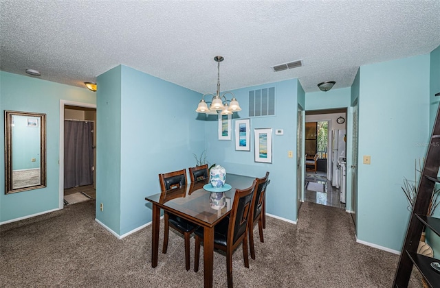 carpeted dining space featuring a textured ceiling and a notable chandelier