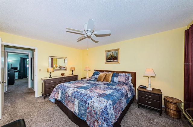 carpeted bedroom with a textured ceiling and ceiling fan