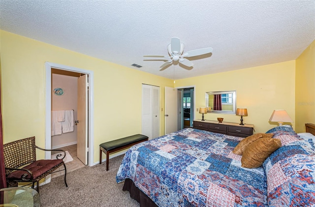 carpeted bedroom with connected bathroom, a closet, ceiling fan, and a textured ceiling