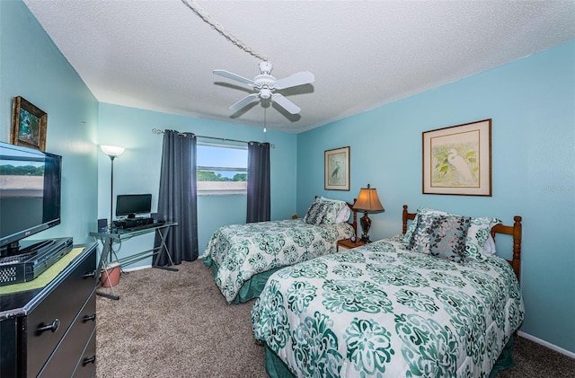 carpeted bedroom with ceiling fan and a textured ceiling