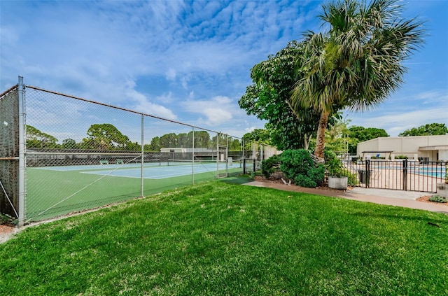 view of sport court with a lawn