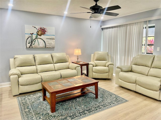 living room with ceiling fan and light wood-type flooring