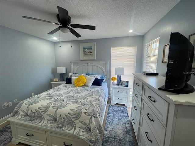 bedroom featuring a textured ceiling and ceiling fan