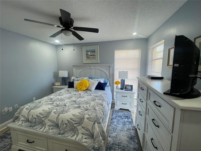 bedroom featuring a textured ceiling and ceiling fan