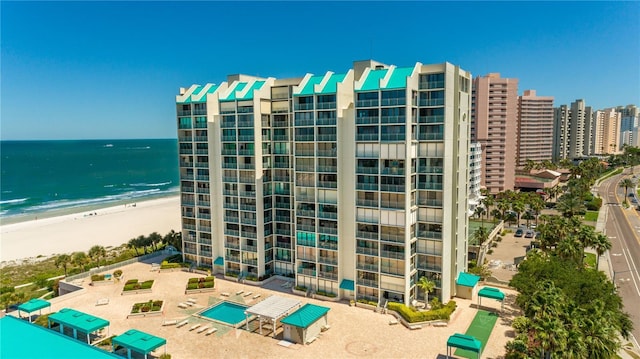 view of property with a water view and a view of the beach