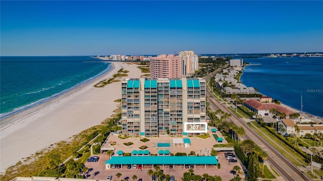 bird's eye view featuring a water view and a beach view