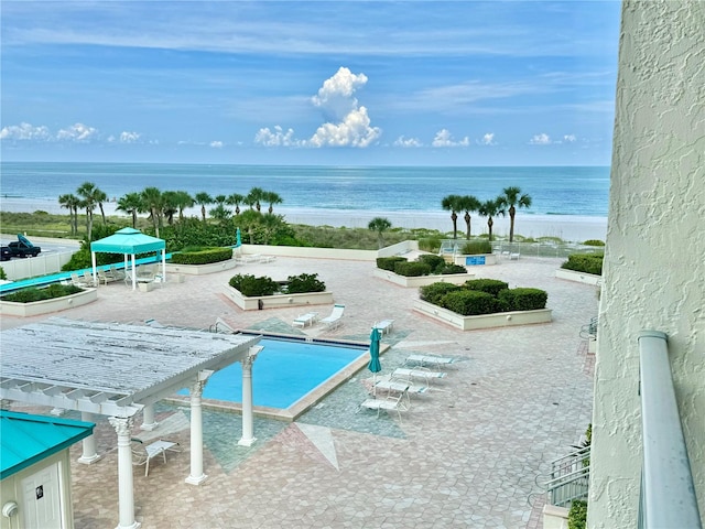 view of swimming pool featuring a water view, fence, a gazebo, and a pergola