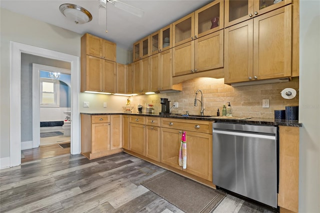 kitchen featuring ceiling fan, wood-type flooring, tasteful backsplash, sink, and stainless steel dishwasher