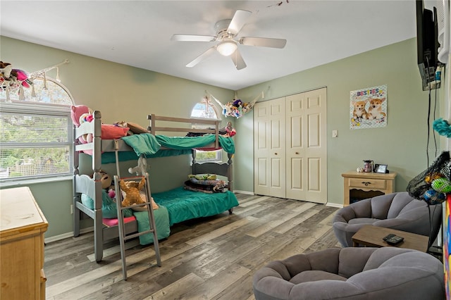 bedroom featuring a closet, wood-type flooring, and ceiling fan