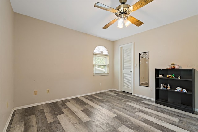 empty room with wood-type flooring and ceiling fan